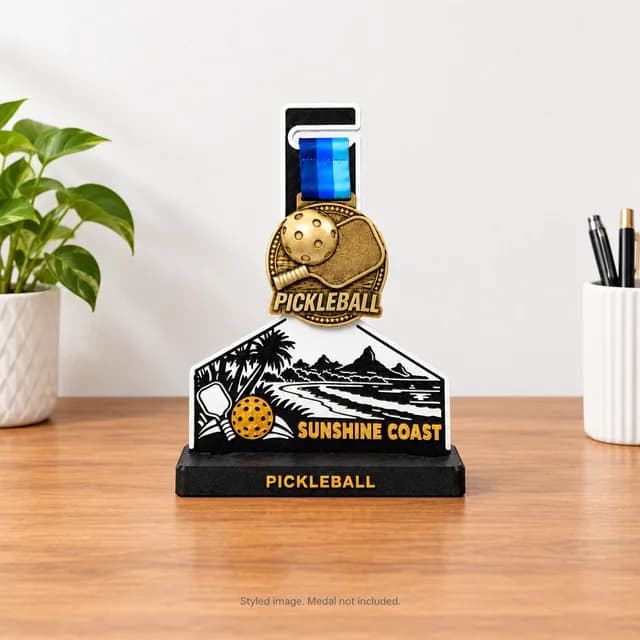 Sunshine Coast medal stand holding a pickleball medal on a desk